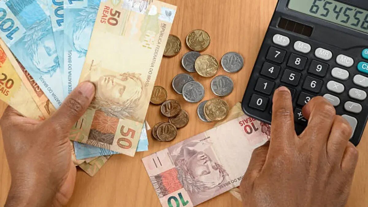 Calculadora e cédulas de real usadas para representar planejamento financeiro